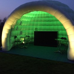 outside the igloo inflatable bar lit in green