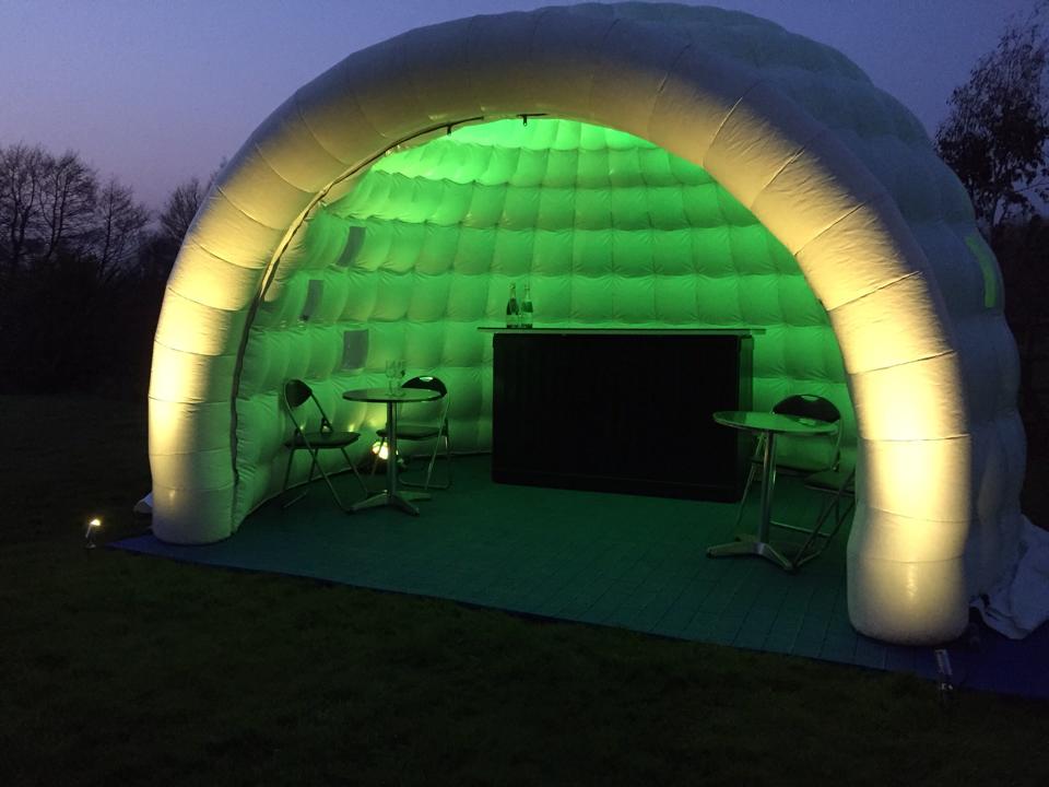 outside the igloo inflatable bar lit in green