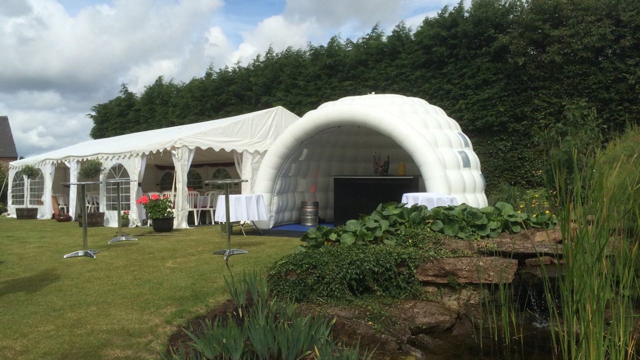 inflatable igloo next to marquee at event