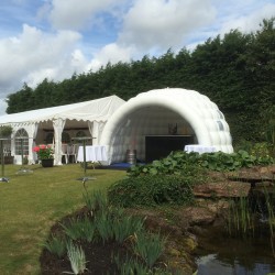 inflatable igloo next to marquee at event