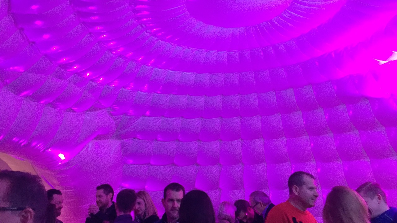 party guests inside inflatable igloo