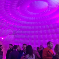 party guests inside inflatable igloo